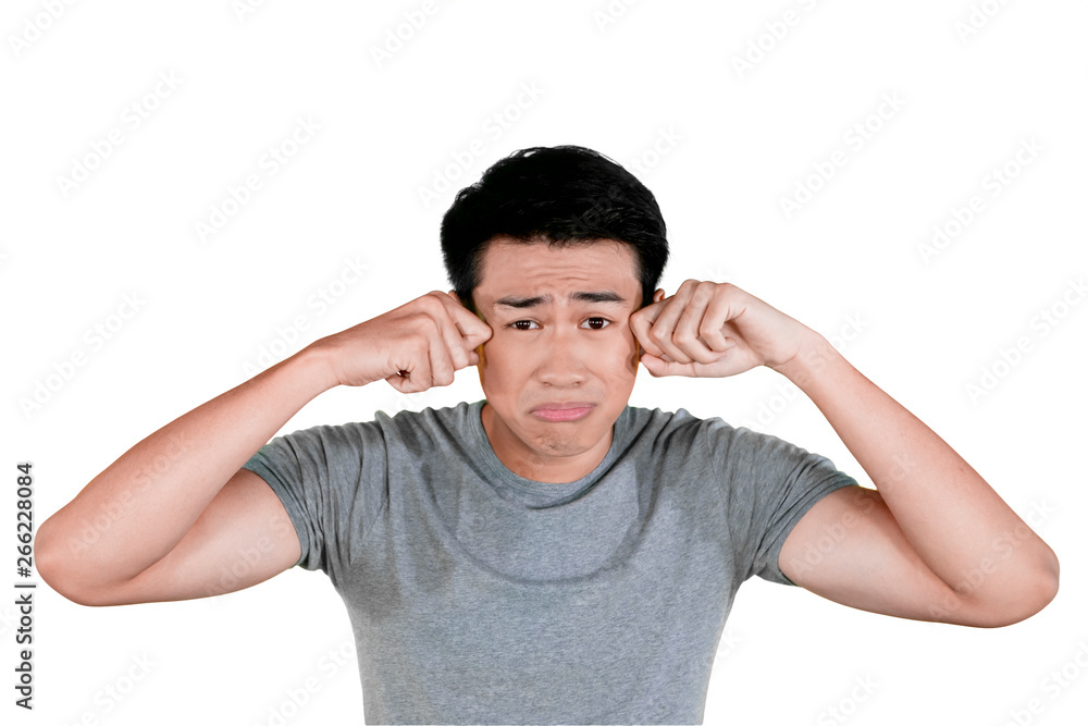 Young Asian man crying in the studio Young Asian man crying in the studio