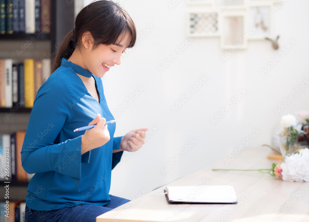 Beautiful portrait young asian woman writer writing on notebook or diary with happy and excited, lifestyle asia girl planning working and success, education and business concept. Beautiful portrait young asian woman writer writing on notebook or diary with happy and excited, lifestyle asia girl planning working and success, education and business concept.