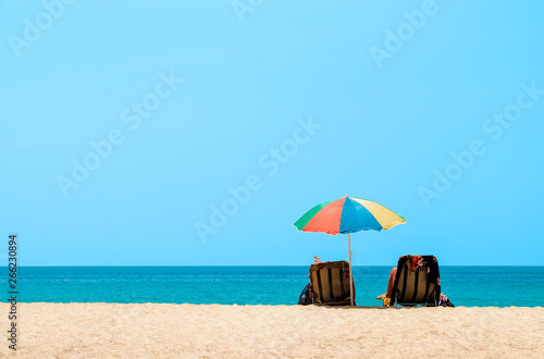 Couple sunbathing and relaxing on beach chairs. Sands and sea view  Summer background - Image
