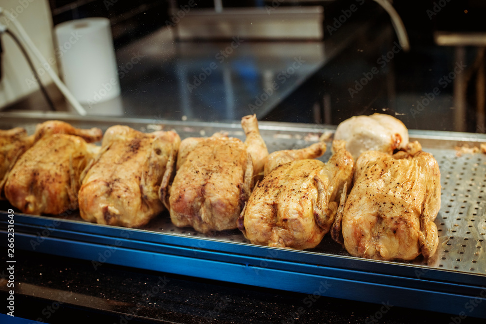 rotisserie grill chicken on a supermarket counter, grilled chicken rotisserie grill chicken on a supermarket counter, grilled chicken