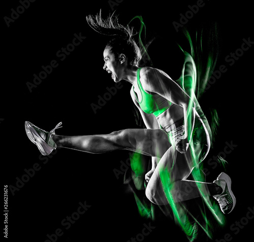 one mixed race woman exercising fitness exercises isolated on black background with lightpainting effect © snaptitude