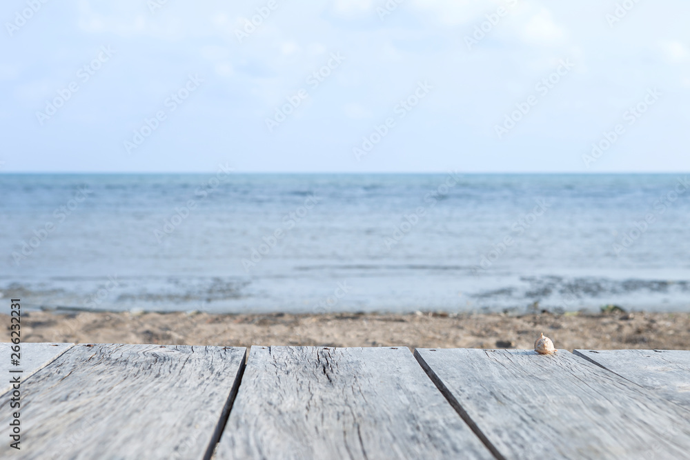 Wooden bench over blurred beach and sea background, outdoor day light, holiday and summer concept background