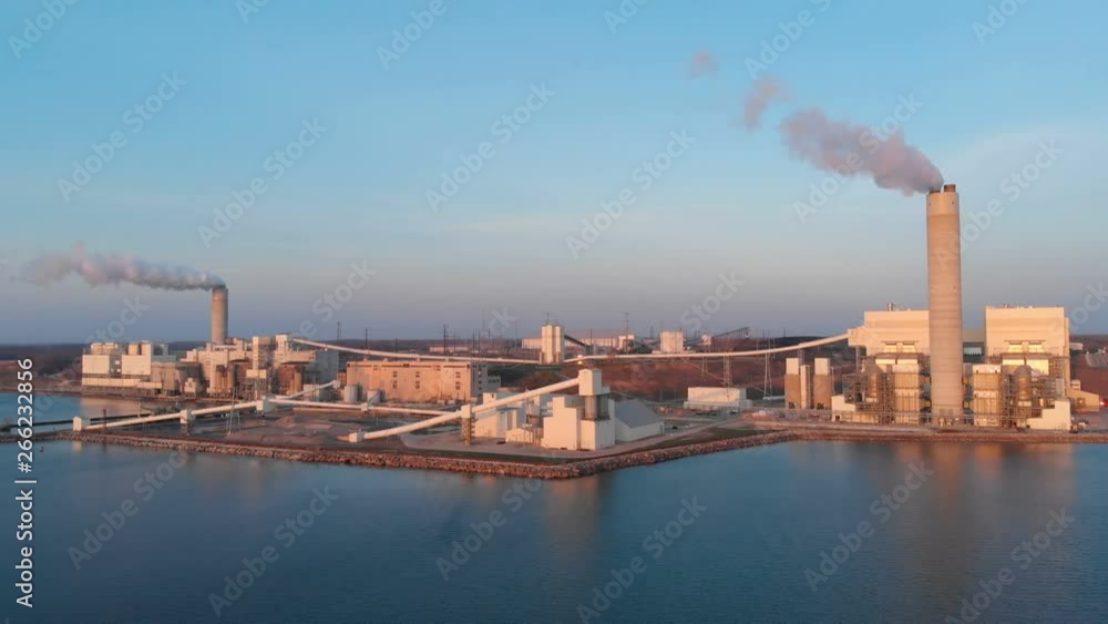 Aerial view of Power Station in Wisconsin (Milwaukee), the coast of Michigan lake at sunrise. Industrial landscape. Plant emissions, environmen pollutions. Drone flying over water Aerial view of Power Station in Wisconsin (Milwaukee), the coast of Michigan lake at sunrise. Industrial landscape. Plant emissions, environmen pollutions. Drone flying over water