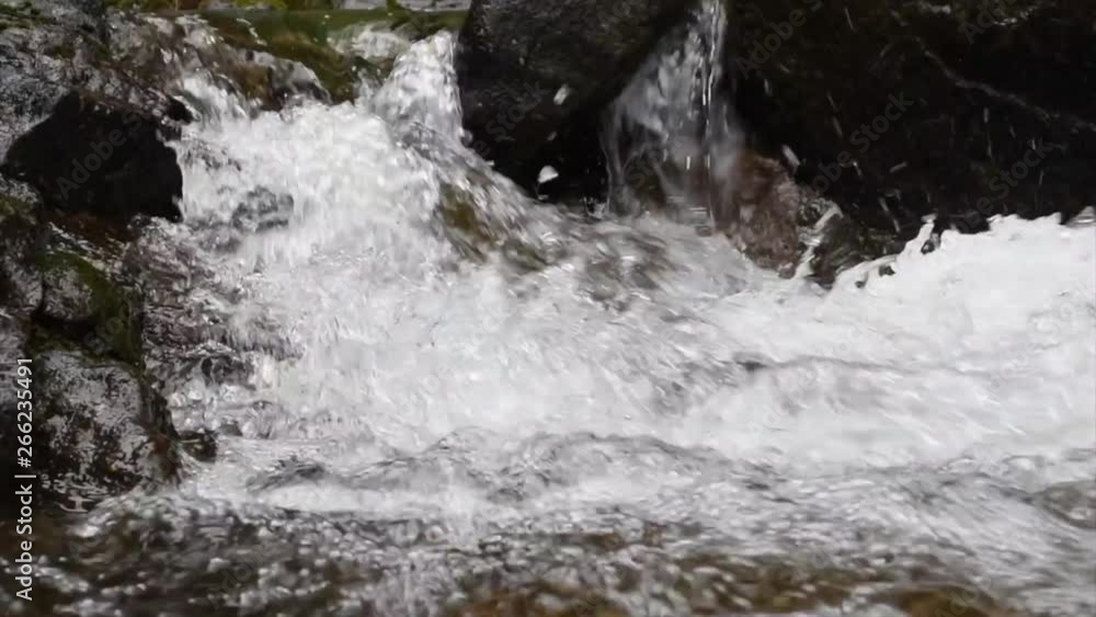 Water cascading down through rocks. The water creates a nice bubbling scene when it hits the water below. Water cascading down through rocks. The water creates a nice bubbling scene when it hits the water below.