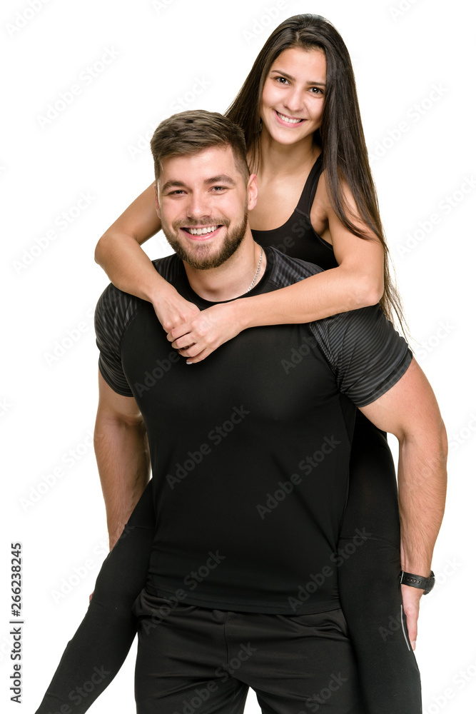 Smiling happy athlete piggybacking his laughing girlfriend Smiling happy athlete piggybacking his laughing girlfriend