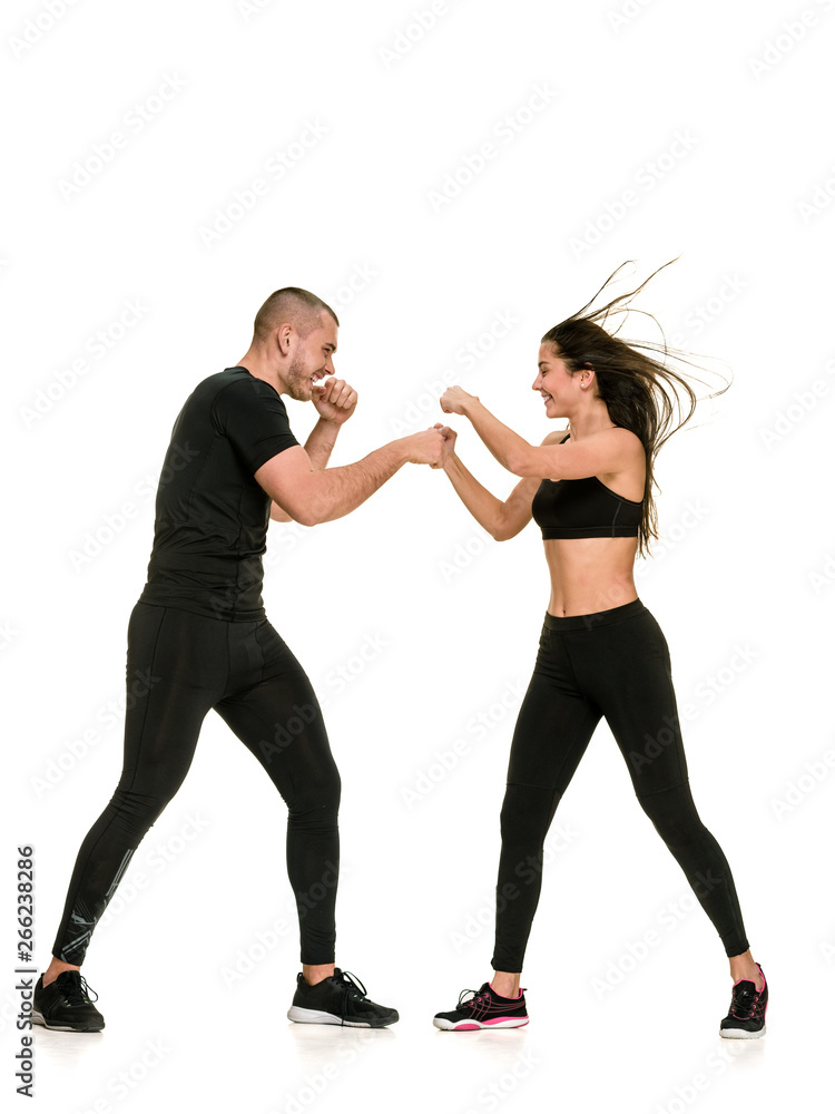 Fit athletic girl having kickboxing training with personal instructor Fit athletic girl having kickboxing training with personal instructor