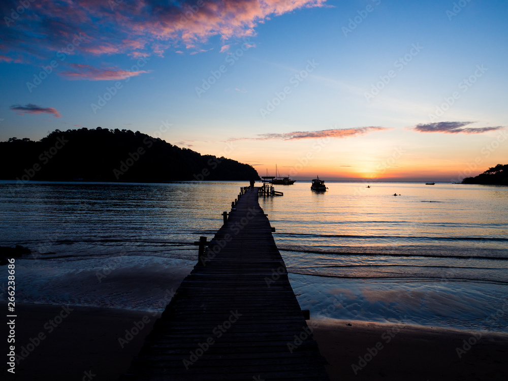 Wood bridge on the sea with a beautiful sunset at koh kood island, Thailand