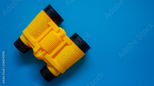 Binocular on blue background