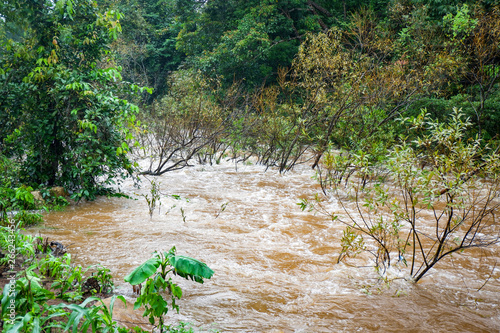 Bild auf Leinwand Water flood on river after heavy rain rapids water flow copiously from mountain