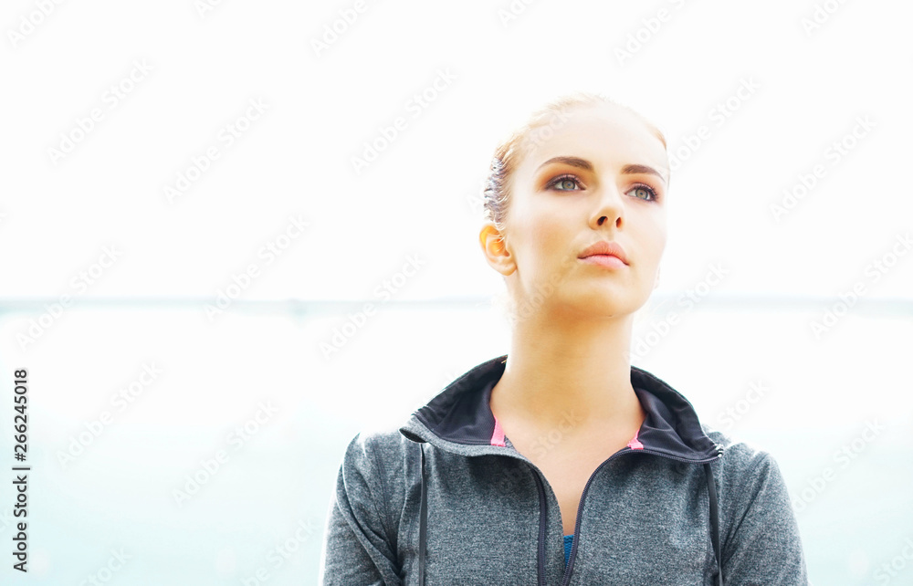 Fototapeta premium Young, fit and sporty brunette girl in sportswear. Woman doing sports outdoor.