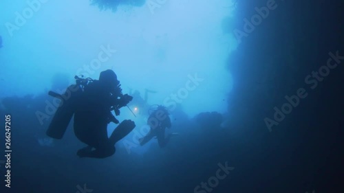 Wallpaper Mural scuba divers diving into a underwater cave in Misool, Raja Ampat. Torontodigital.ca