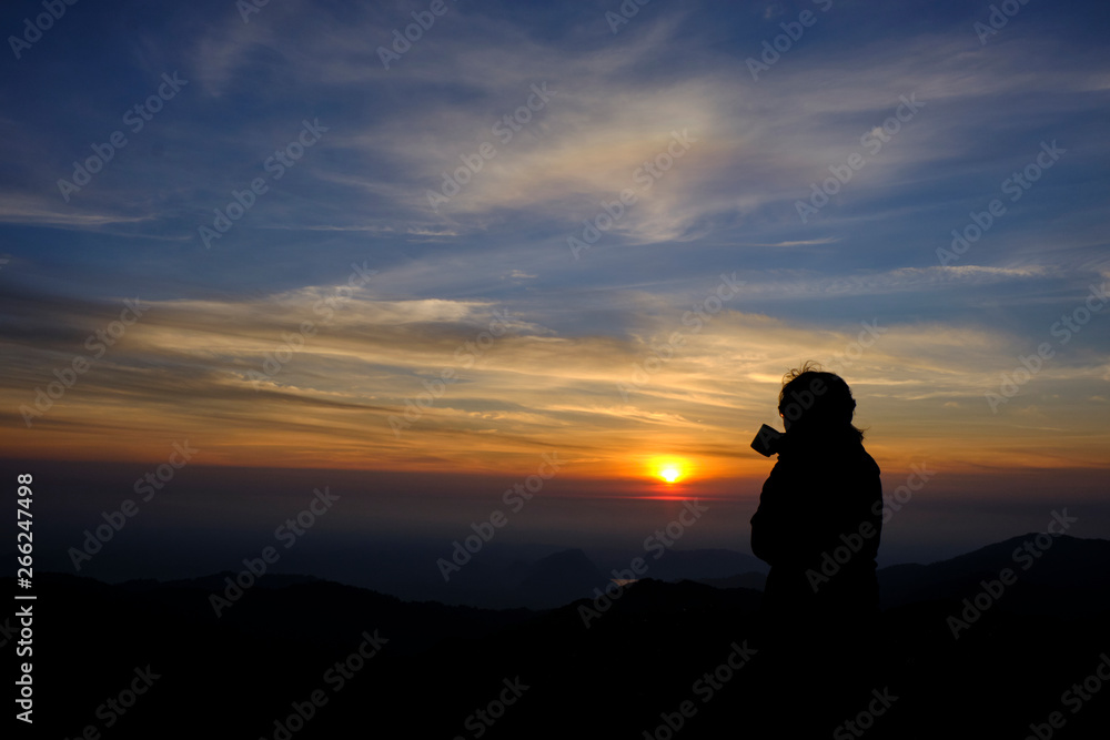 silhouette style. Beautiful girl charming stand coffee and enjoy the view the beauty of nature. During the morning sunrise hours Gold Mountain View and the beautiful from a high angle.