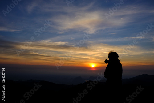 silhouette style. Beautiful girl charming stand coffee and enjoy the view the beauty of nature. During the morning sunrise hours Gold Mountain View and the beautiful from a high angle.