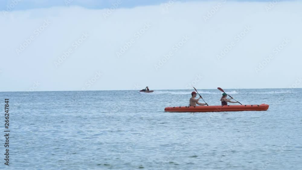background on the sea floating kayak for two and jet ski background on the sea floating kayak for two and jet ski