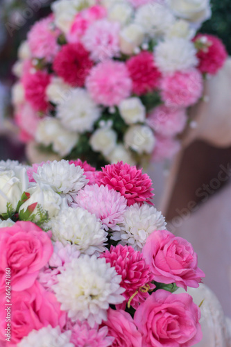 Plastic pink  red and white flowers for wedding ceremony.
