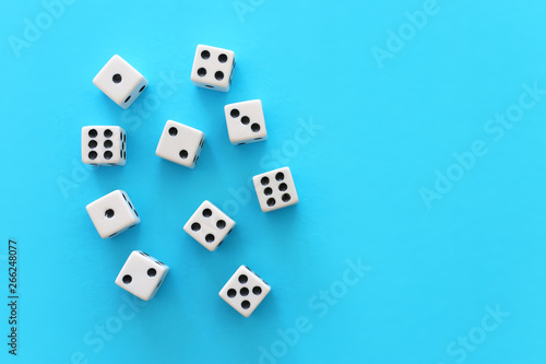 Rolling Dices over blue background. Casino gambling concept