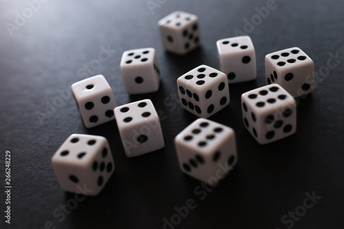 Rolling Dices over black background. Casino gambling concept