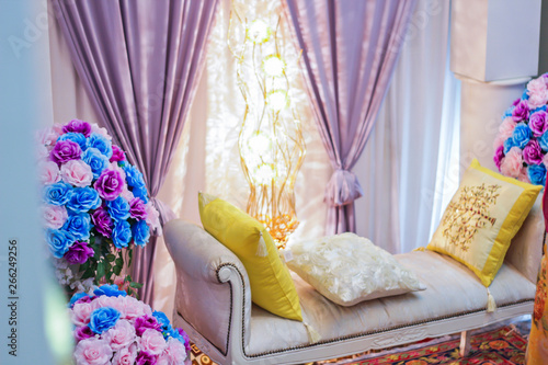 Malay wedding bridal stage or Pelamin in Malaysia decorated with colorful flowers.