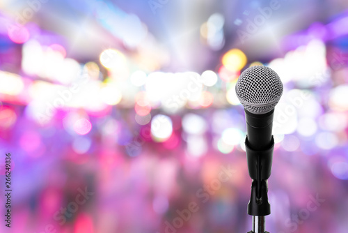 Microphone on stage ..Close up of dynamic microphone setting on stand with colorful light bokeh background ,celebration event .