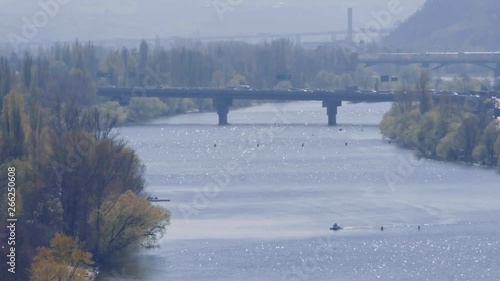 Prague River Vltava With Traffic On a Bridge and Rowers photo