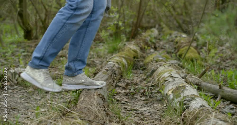 Close-up of a woman feet walking in a birch forest in a green area. To go through obstacles. Shoot with RED camera. Close-up of a woman feet walking in a birch forest in a green area. To go through obstacles. Shoot with RED camera.
