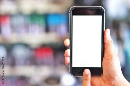 The woman's hand is holding the phone in his hand. The phone has a white screen.