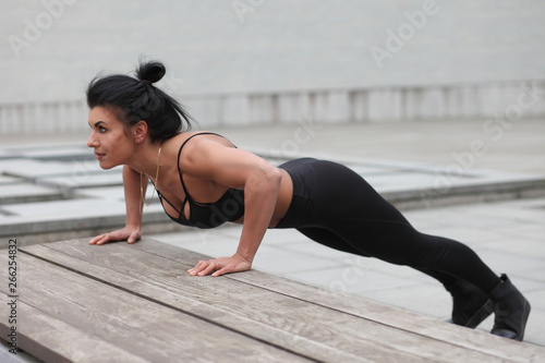 young strong muscular girl doing exercises