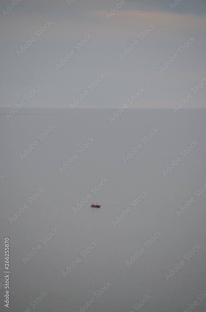 ocean scene with misty gray clouds and fishing boat at Glenelg South Australia ocean scene with misty gray clouds and fishing boat at Glenelg South Australia