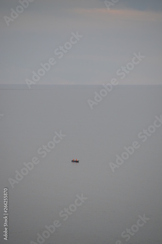 ocean scene with misty gray clouds and fishing boat at Glenelg South Australia
