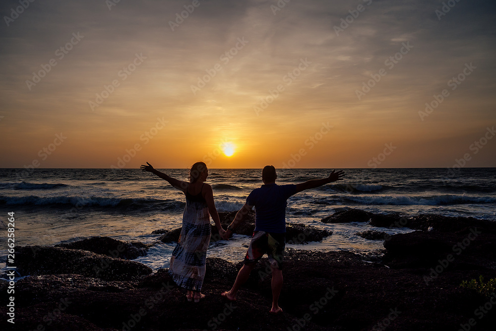 Fototapeta premium Young couple in love on the beach February 14, St. Valentine's Day sunset Goa India vacation trip .travel new year in a tropical country. freedom concept