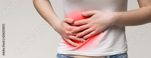 Young woman having painful stomach ache. Chronic gastritis