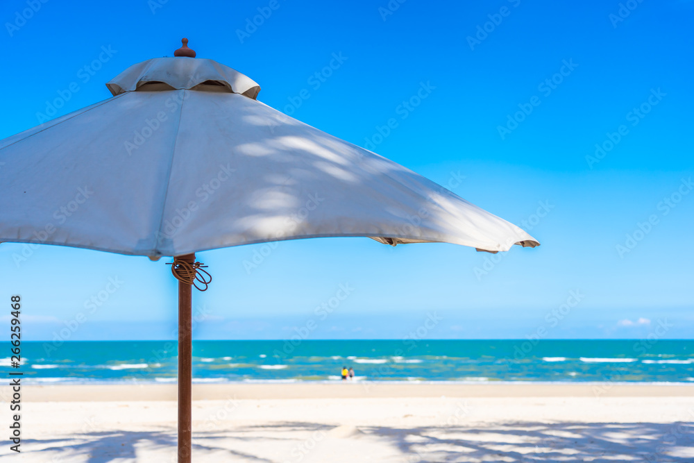 Umbrella and chair on the tropical beach and sea ocean