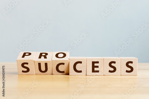 Process for success concept. Wooden cube block flip over word process to success on wood table photo