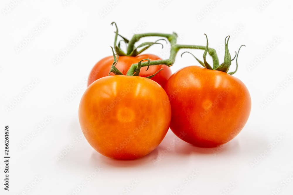 Three red tomatoes with branch Three red tomatoes with branch