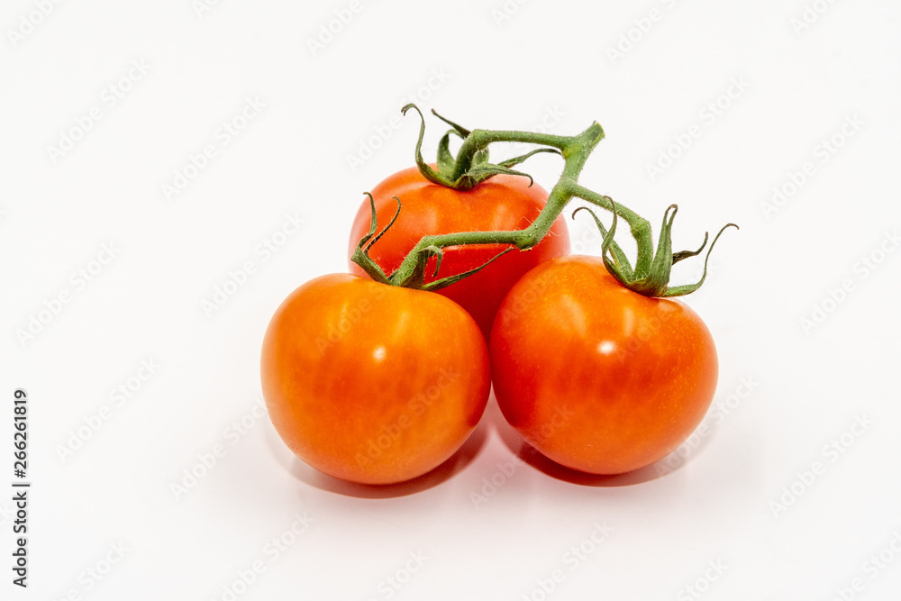 Three red tomatoes with branch Three red tomatoes with branch