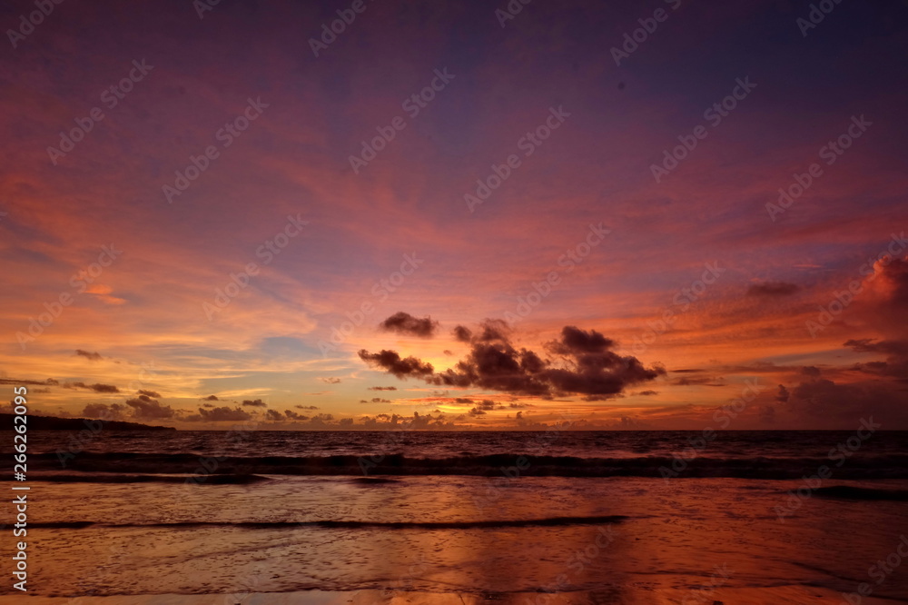 the beauty of Jimbaran beach in Bali Indonesia at dusk with the sun disappearing