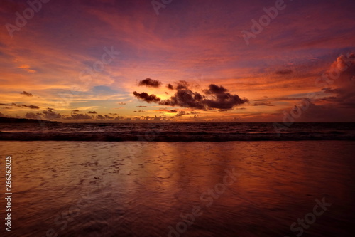 the beauty of Jimbaran beach in Bali Indonesia at dusk with the sun disappearing © onyengradar