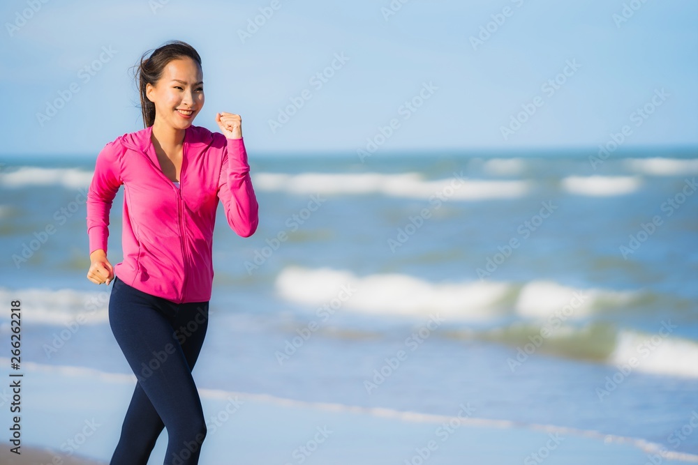 Portrait beautiful young asian woman running or exercise on the tropica nature landscape of beach Portrait beautiful young asian woman running or exercise on the tropica nature landscape of beach
