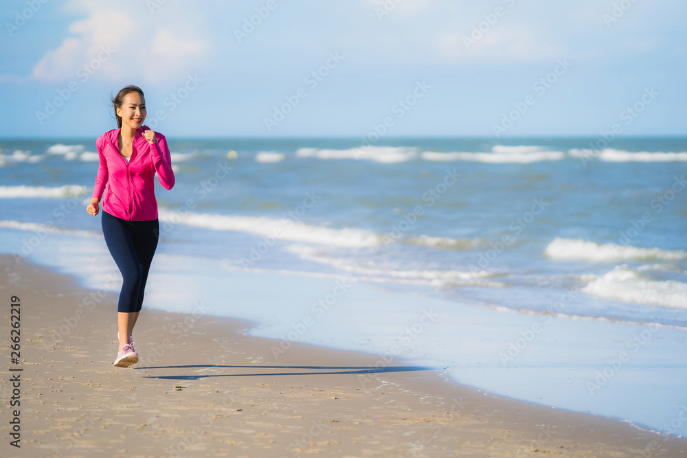 Portrait beautiful young asian woman running or exercise on the tropica nature landscape of beach Portrait beautiful young asian woman running or exercise on the tropica nature landscape of beach