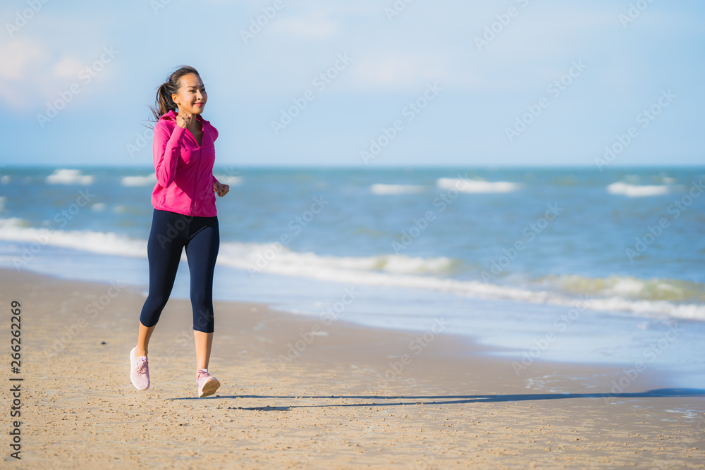 Portrait beautiful young asian woman running or exercise on the tropica nature landscape of beach Portrait beautiful young asian woman running or exercise on the tropica nature landscape of beach