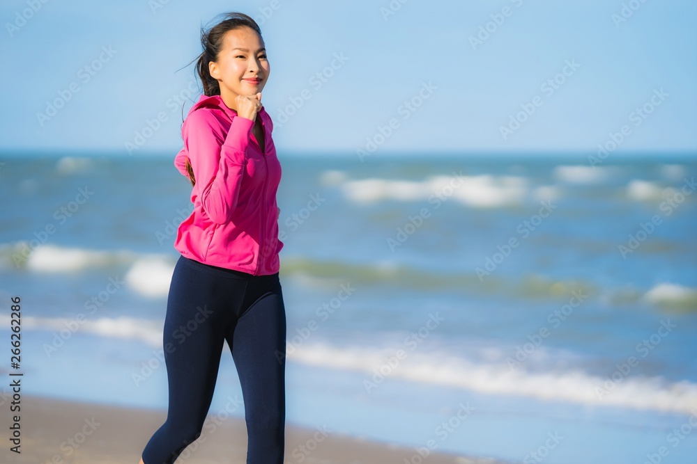 Portrait beautiful young asian woman running or exercise on the tropica nature landscape of beach Portrait beautiful young asian woman running or exercise on the tropica nature landscape of beach