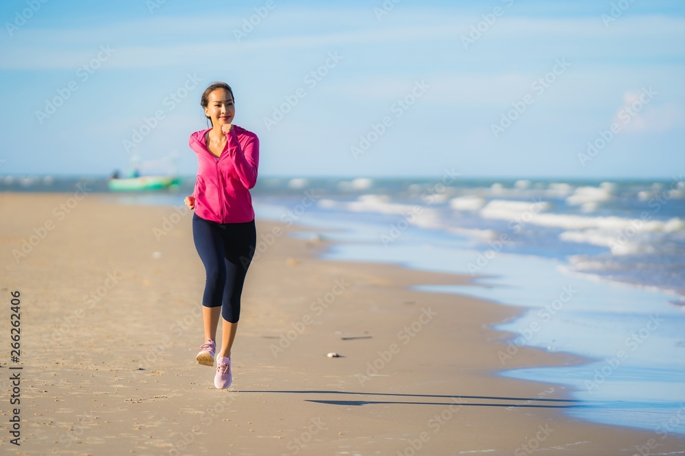 Portrait beautiful young asian woman running or exercise on the tropica nature landscape of beach Portrait beautiful young asian woman running or exercise on the tropica nature landscape of beach