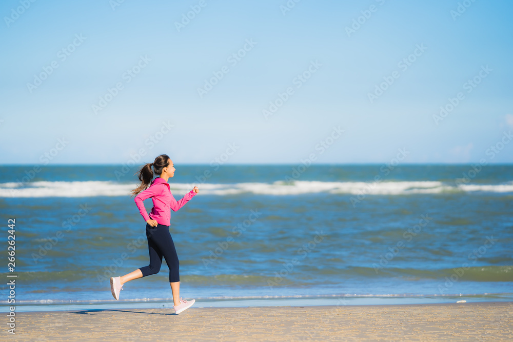 Portrait beautiful young asian woman running or exercise on the tropica nature landscape of beach Portrait beautiful young asian woman running or exercise on the tropica nature landscape of beach