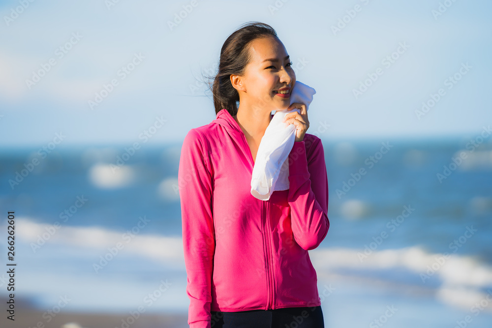 Portrait beautiful young asian woman running or exercise on the tropica nature landscape of beach Portrait beautiful young asian woman running or exercise on the tropica nature landscape of beach