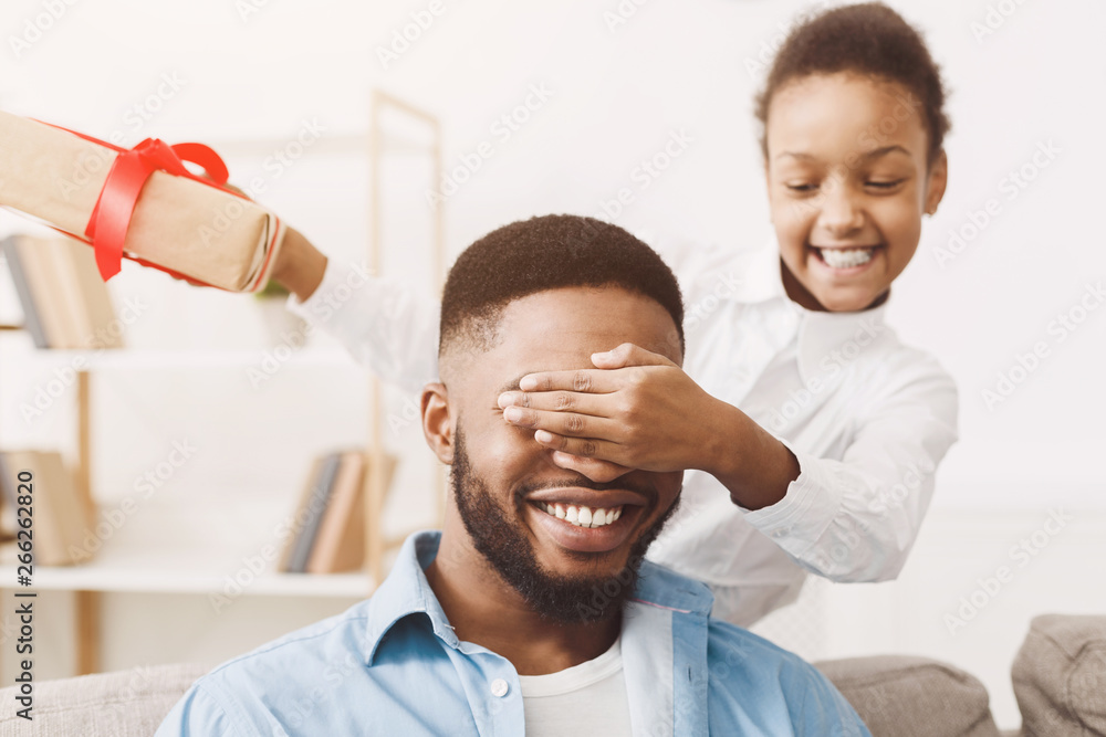 Little daughter giving birthday present to daddy Little daughter giving birthday present to daddy
