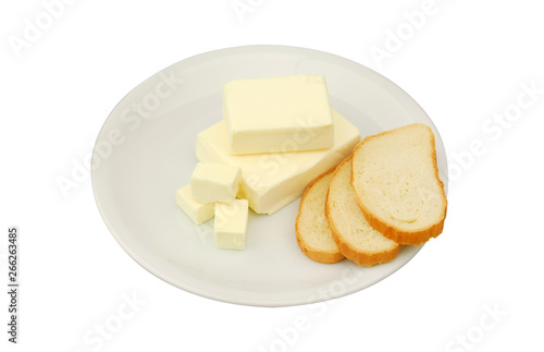 Butter and slices of bread are lying on a plate on a white isolated background