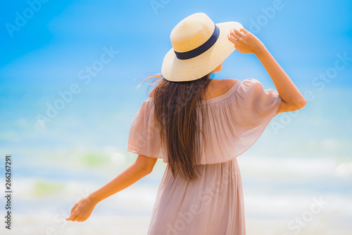Portrait beautiful young asian woman smile happy walk on the tropical outdoor nature beach sea