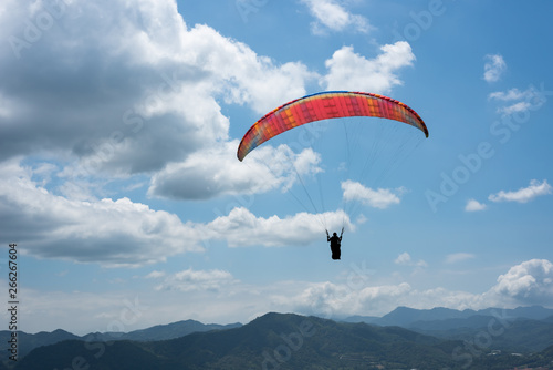 colorful paragliding under blue sky