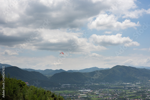 paragliding under blue sky in the town