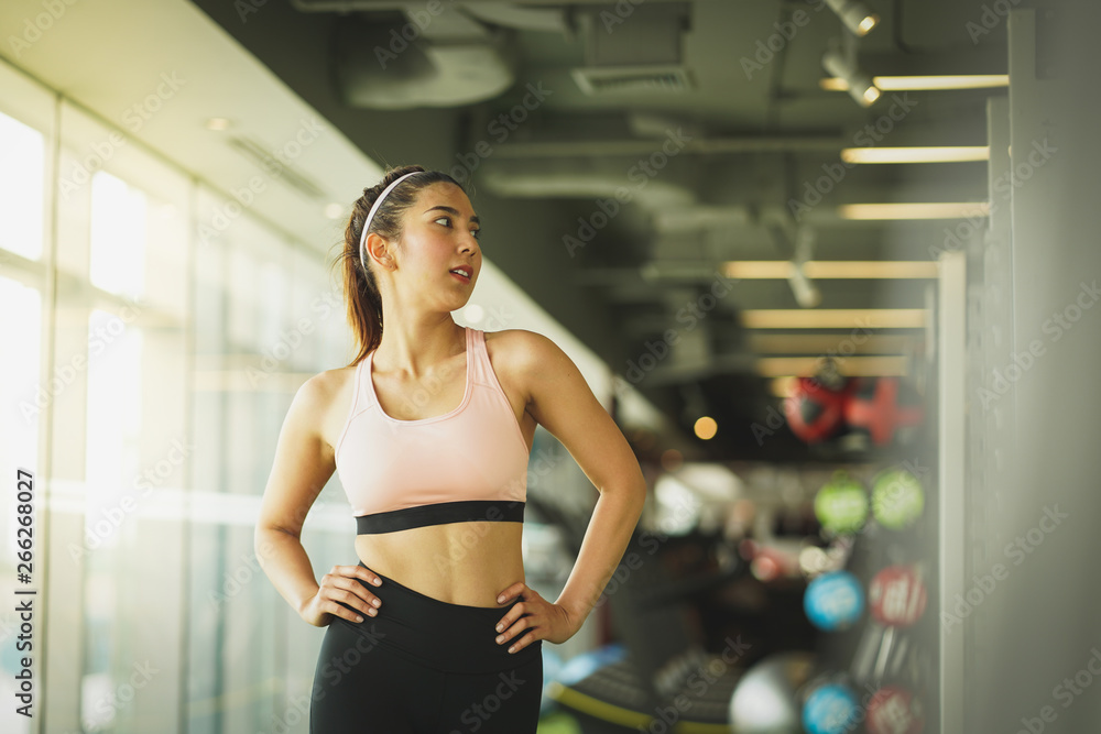 A portrait of an Thai woman working on in the gym